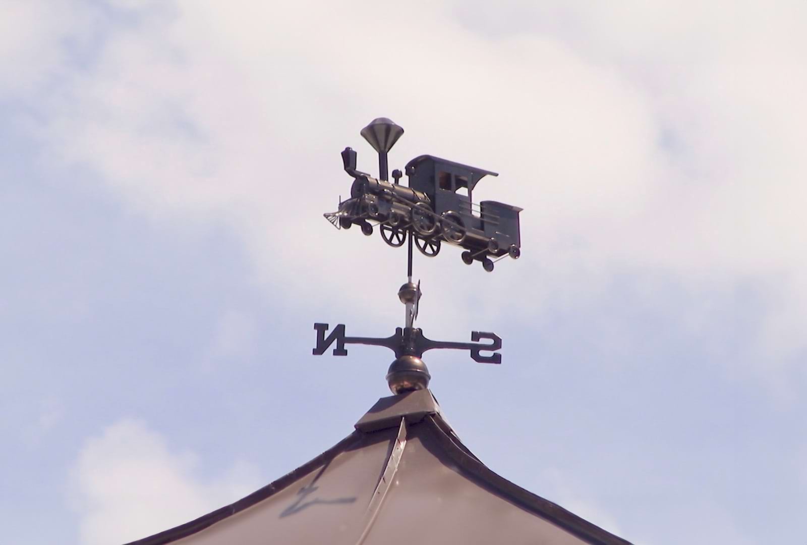 a compass on a building top
